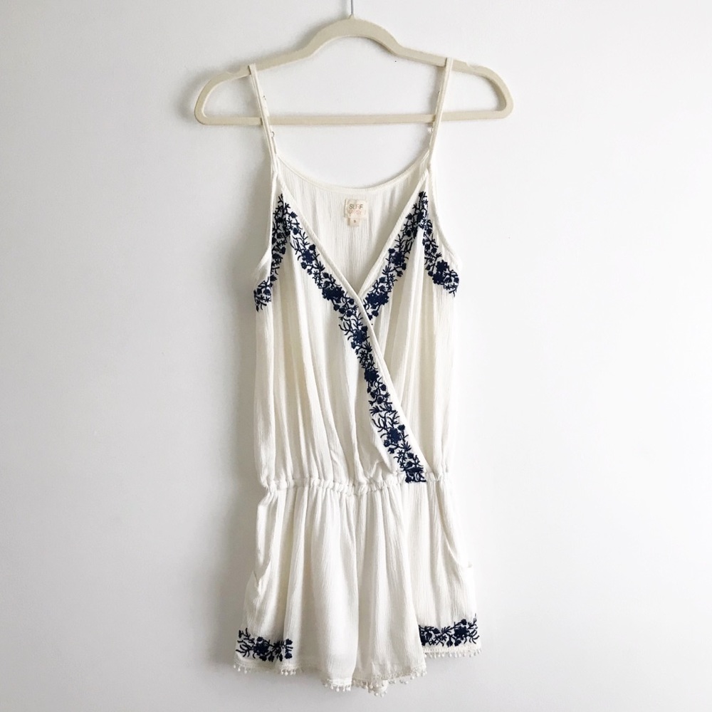 Delicate white romper with navy floral embroidery